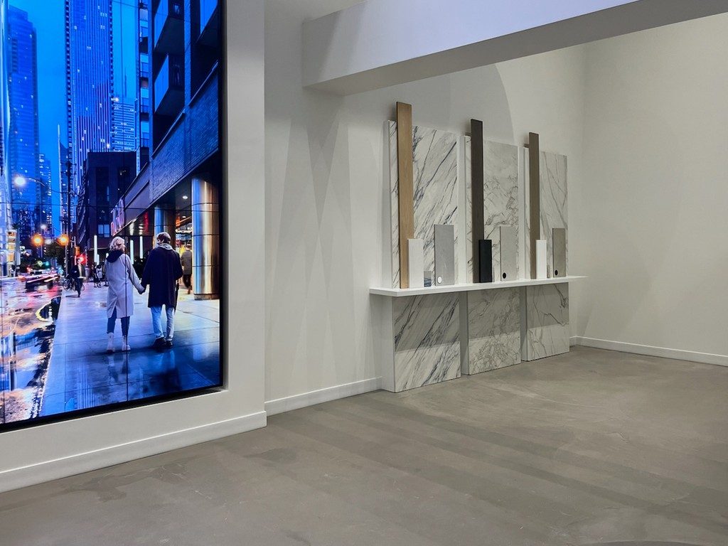 Colour-Selection Commercial Sales Office Interior with marble display panels overlooking a city street, project by colorlab.